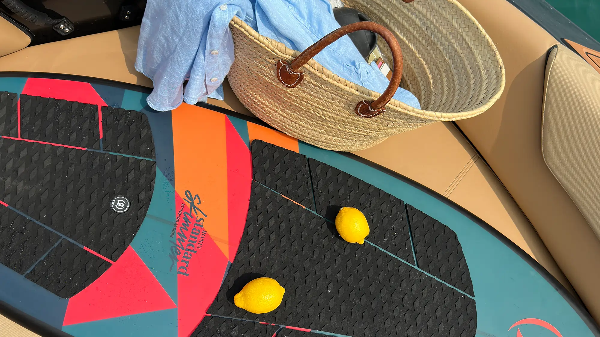 surf board with two lemon on top of it laying on a boat